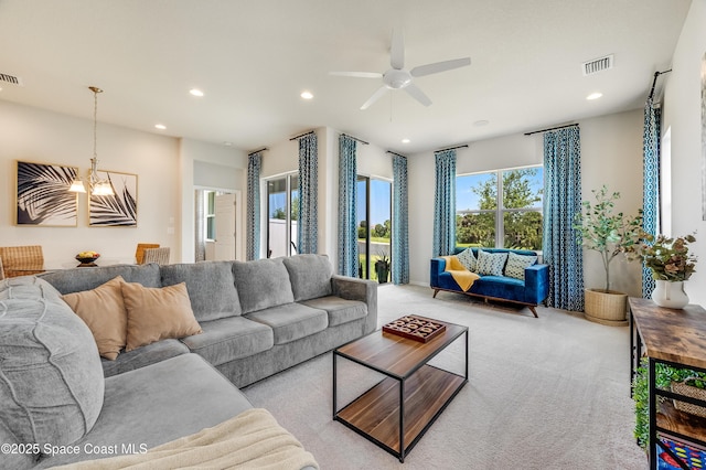 2679 Avalonia Dr, Melbourne, FL 32940 - carpeted living area with a chandelier, ceiling fan, and recessed lighting