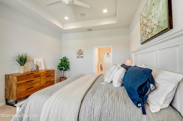 2679 Avalonia Dr, Melbourne, FL 32940 - carpeted bedroom featuring a tray ceiling, recessed lighting, ceiling fan, and connected bathroom
