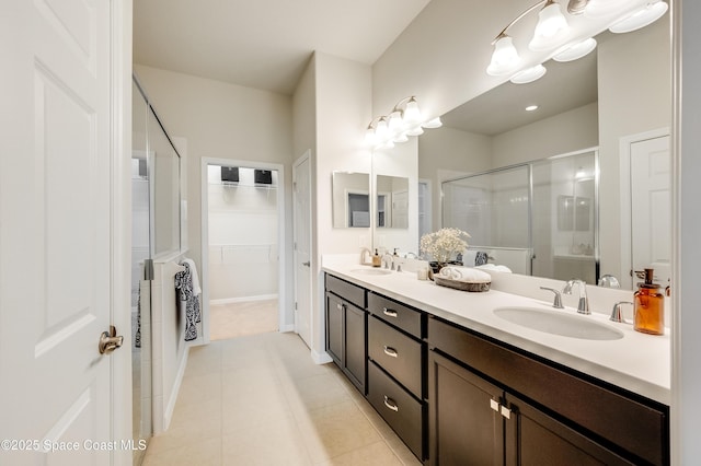 2679 Avalonia Dr, Melbourne, FL 32940 - full bathroom with a shower stall, double vanity, a walk in closet, and tile patterned floors
