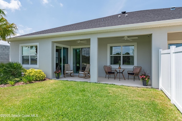 2679 Avalonia Dr, Melbourne, FL 32940 - back of property featuring a ceiling fan, stucco siding, roof with shingles, and a patio