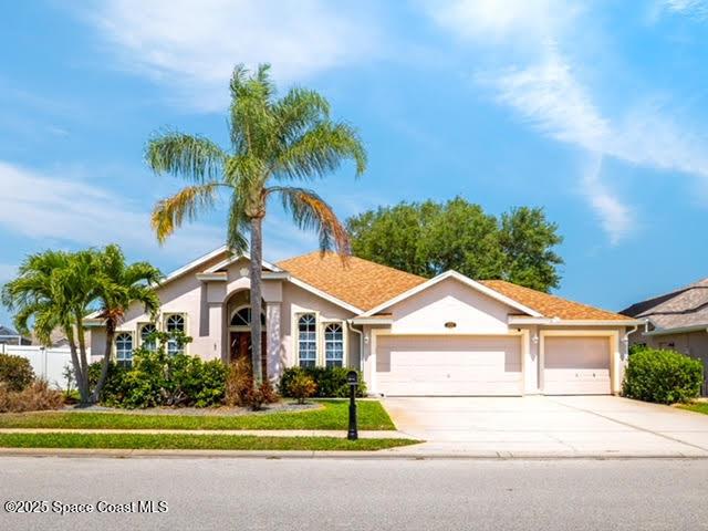 4040 Estancia Way, Melbourne, FL 32934 - ranch-style home featuring a garage, driveway, and stucco siding