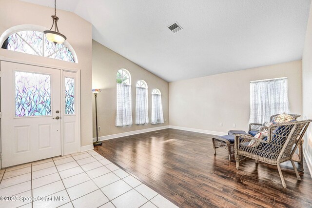 4040 Estancia Way, Melbourne, FL 32934 - entryway with wood finished floors, baseboards, and high vaulted ceiling