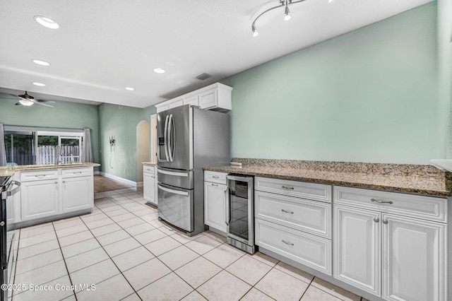 4040 Estancia Way, Melbourne, FL 32934 - kitchen featuring wine cooler, stainless steel fridge with ice dispenser, white cabinets, recessed lighting, and light tile patterned floors