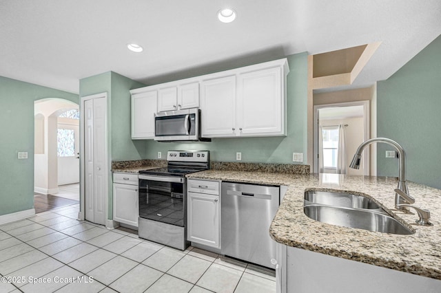 4040 Estancia Way, Melbourne, FL 32934 - kitchen with stainless steel appliances, a sink, arched walkways, plenty of natural light, and recessed lighting