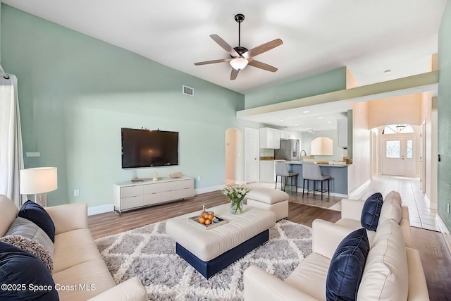 4040 Estancia Way, Melbourne, FL 32934 - living area featuring a ceiling fan, light wood-type flooring, baseboards, and high vaulted ceiling