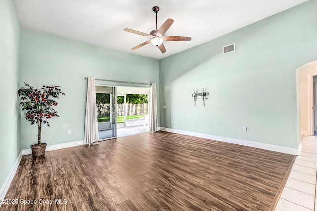 4040 Estancia Way, Melbourne, FL 32934 - unfurnished room featuring a ceiling fan, wood finished floors, baseboards, and arched walkways