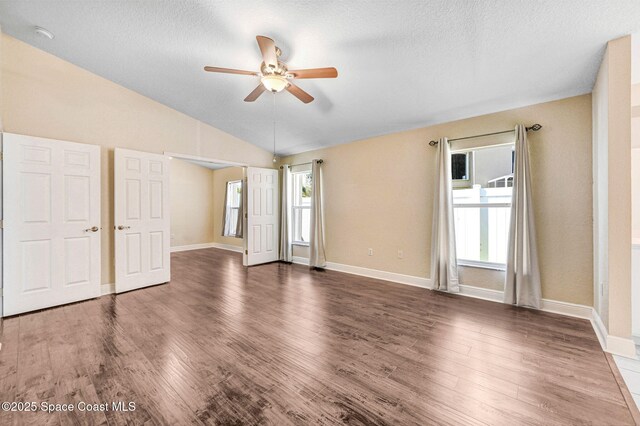 4040 Estancia Way, Melbourne, FL 32934 - empty room with ceiling fan, a textured ceiling, wood finished floors, baseboards, and lofted ceiling