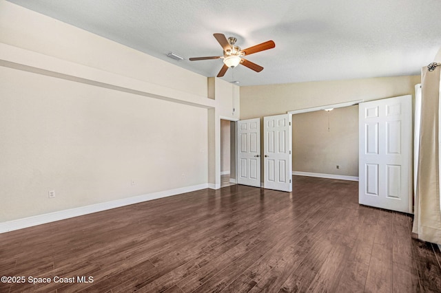 4040 Estancia Way, Melbourne, FL 32934 - unfurnished bedroom featuring vaulted ceiling, dark wood finished floors, baseboards, a textured ceiling, and a ceiling fan