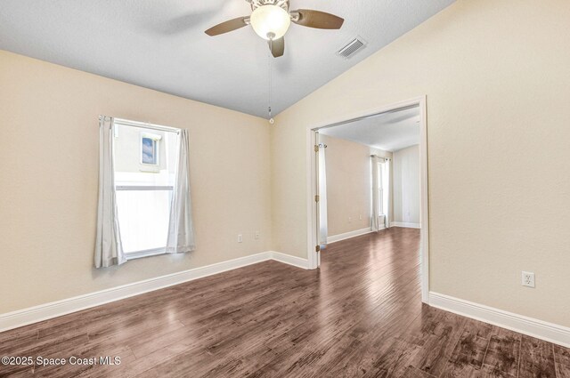 4040 Estancia Way, Melbourne, FL 32934 - unfurnished room featuring lofted ceiling, a ceiling fan, wood finished floors, and baseboards