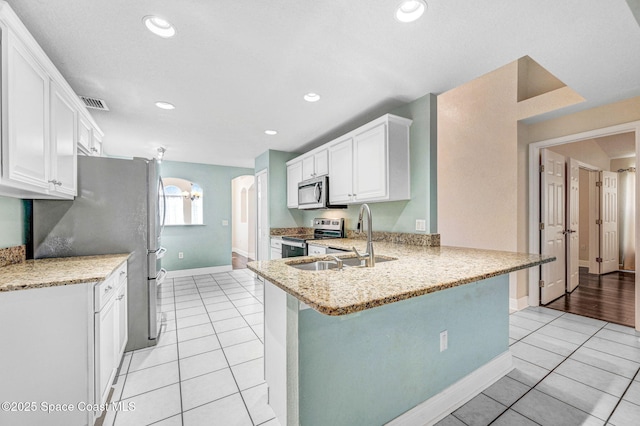 4040 Estancia Way, Melbourne, FL 32934 - kitchen featuring appliances with stainless steel finishes, light tile patterned flooring, a sink, baseboards, and recessed lighting