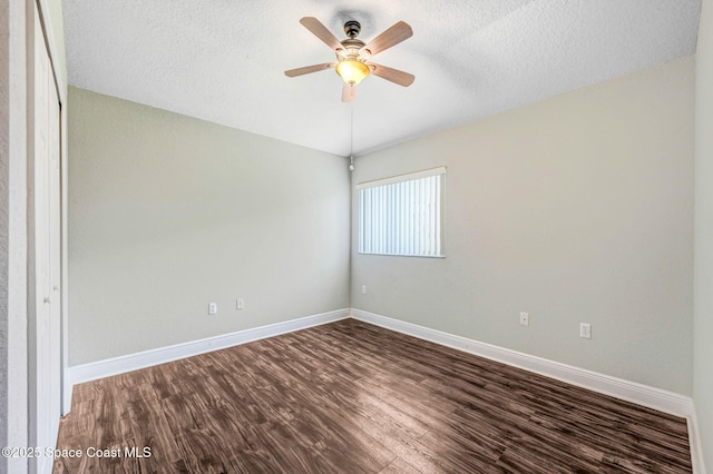4040 Estancia Way, Melbourne, FL 32934 - unfurnished room featuring dark wood-type flooring, a ceiling fan, a textured ceiling, and baseboards