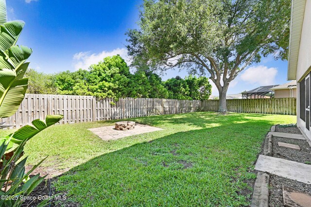 4040 Estancia Way, Melbourne, FL 32934 - view of yard with an outdoor fire pit and a patio
