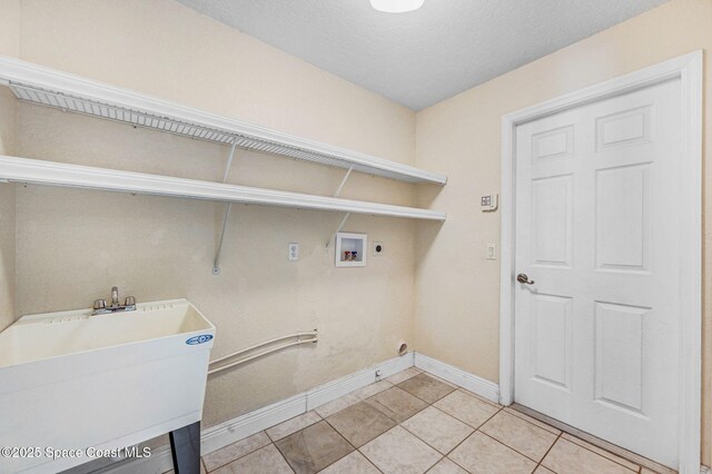 4040 Estancia Way, Melbourne, FL 32934 - washroom featuring baseboards, light tile patterned flooring, washer hookup, electric dryer hookup, and a textured ceiling