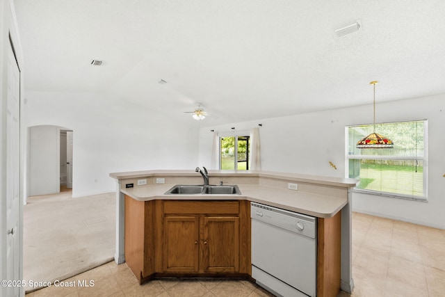 701 Agena Ave NW, Palm Bay, FL 32907 - kitchen featuring white dishwasher, a sink, ceiling fan, brown cabinets, and vaulted ceiling