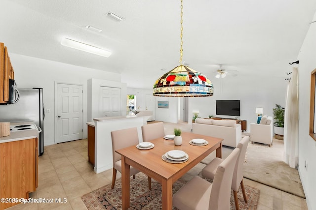 701 Agena Ave NW, Palm Bay, FL 32907 - dining room with a ceiling fan and light tile patterned floors