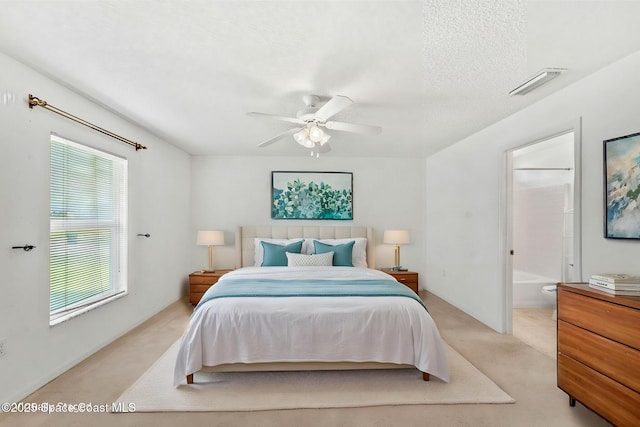 701 Agena Ave NW, Palm Bay, FL 32907 - bedroom featuring light colored carpet, a ceiling fan, and ensuite bath