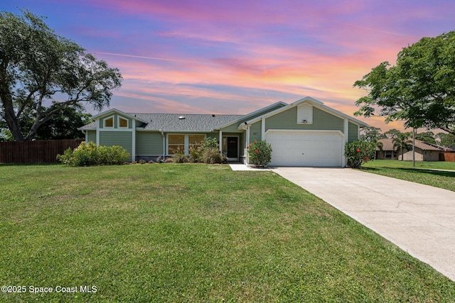 ranch-style home featuring a garage and driveway