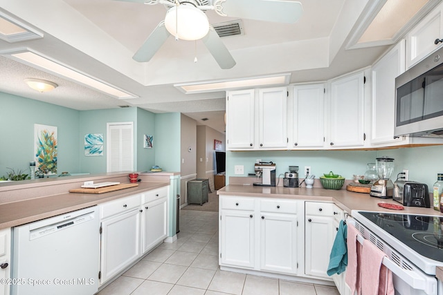 kitchen with white appliances, light tile patterned flooring, white cabinetry, light countertops, and a ceiling fan