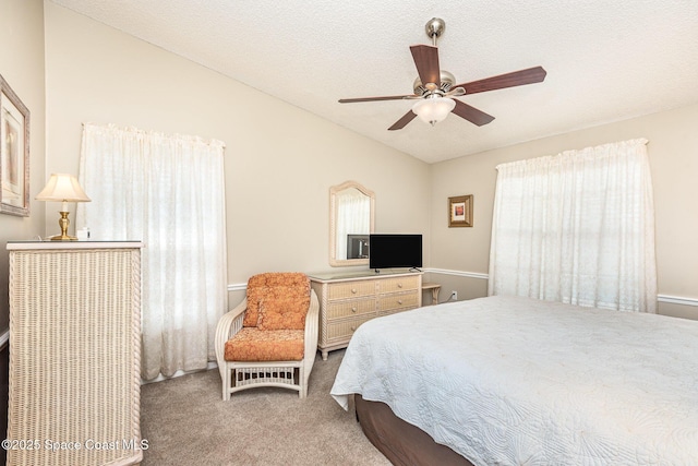 bedroom with vaulted ceiling, carpet floors, and ceiling fan