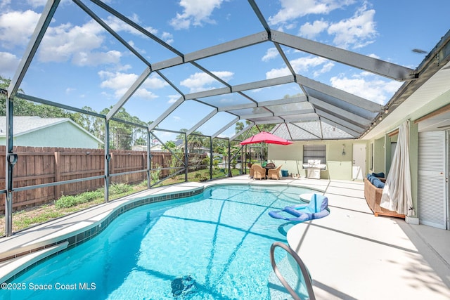 view of pool featuring fence, a patio area, and glass enclosure
