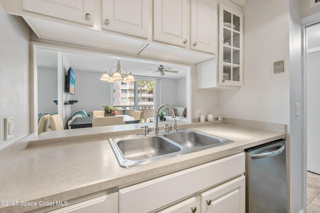 kitchen featuring a sink, dishwasher, light countertops, and white cabinetry
