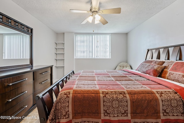 bedroom featuring a textured ceiling and ceiling fan