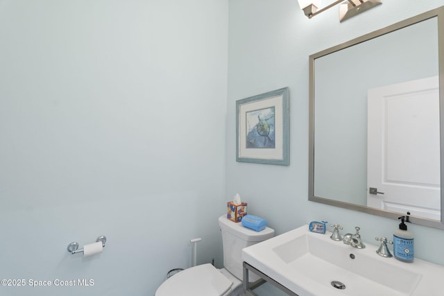half bathroom with a sink and toilet