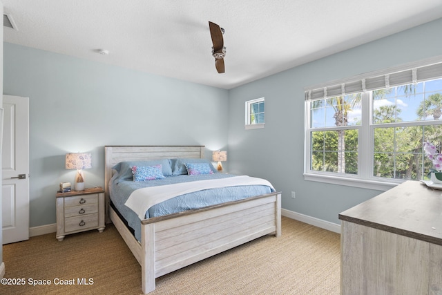 bedroom featuring carpet floors, baseboards, and a ceiling fan