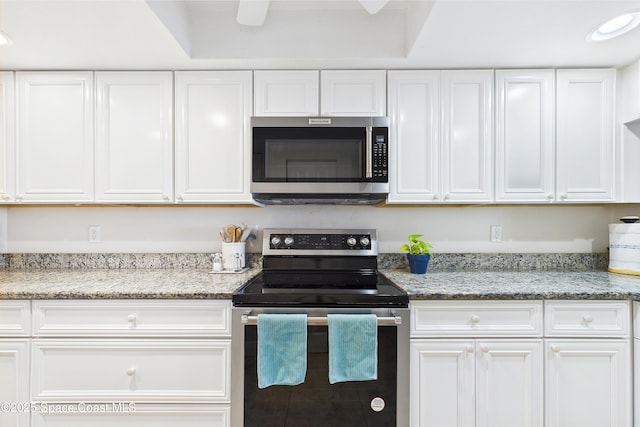 kitchen with stainless steel appliances and white cabinets