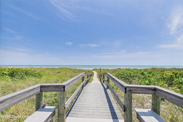 surrounding community featuring view of water and beach