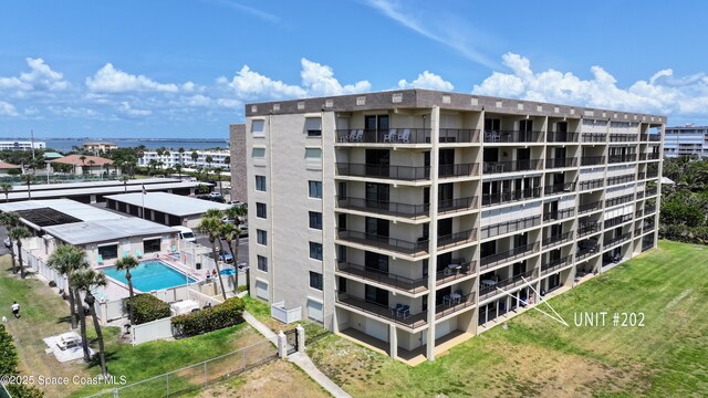 view of apartment building / complex featuring fence