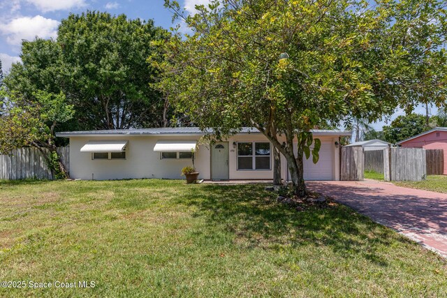 1751 5th Ct, Vero Beach, FL 32960 - single story home with decorative driveway, a garage, metal roof, and concrete block siding