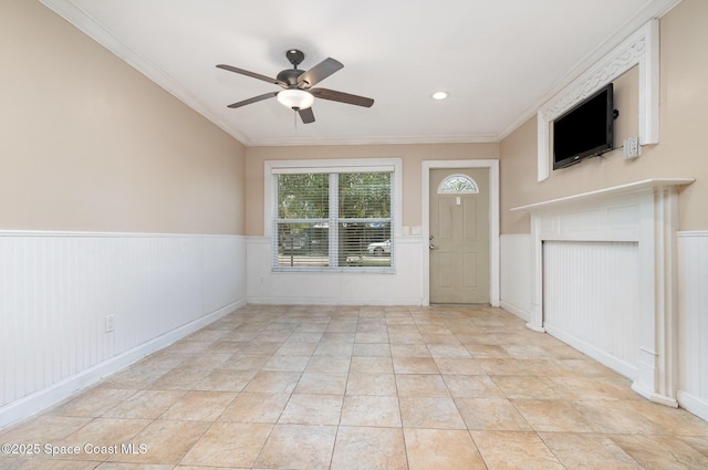 1751 5th Ct, Vero Beach, FL 32960 - unfurnished living room with ceiling fan, wainscoting, ornamental molding, and light tile patterned flooring