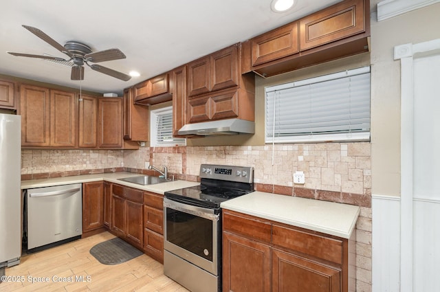 1751 5th Ct, Vero Beach, FL 32960 - kitchen featuring stainless steel appliances, a sink, ceiling fan, light countertops, and under cabinet range hood