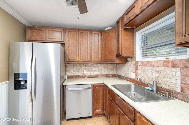 1751 5th Ct, Vero Beach, FL 32960 - kitchen featuring appliances with stainless steel finishes, a sink, and brown cabinets