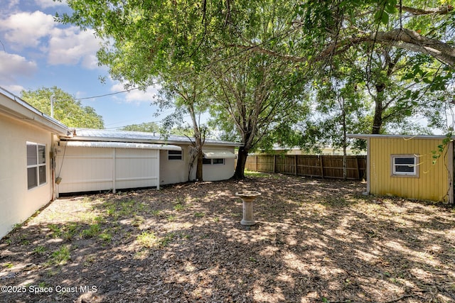 1751 5th Ct, Vero Beach, FL 32960 - view of yard featuring fence, an outbuilding, and a storage shed