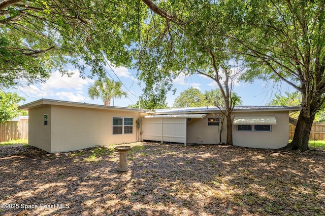 1751 5th Ct, Vero Beach, FL 32960 - back of house featuring fence and concrete block siding