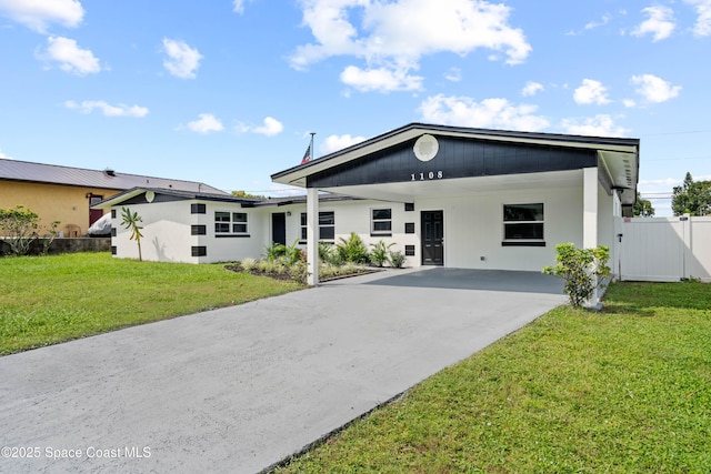 1108 Vineland St, Cocoa, FL 32927 - mid-century home featuring driveway and an attached carport