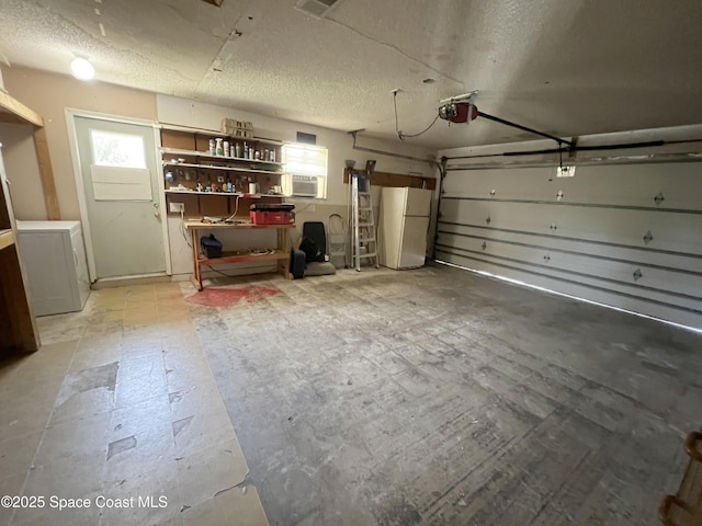 garage with freestanding refrigerator, a garage door opener, and washer / dryer