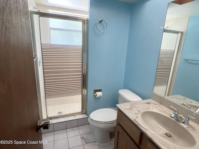 full bathroom with a stall shower, toilet, vanity, and tile patterned floors