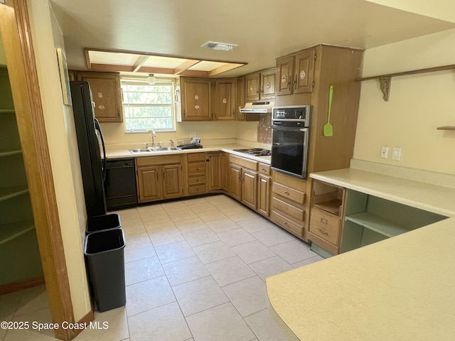 kitchen with black appliances, a sink, under cabinet range hood, and light tile patterned floors