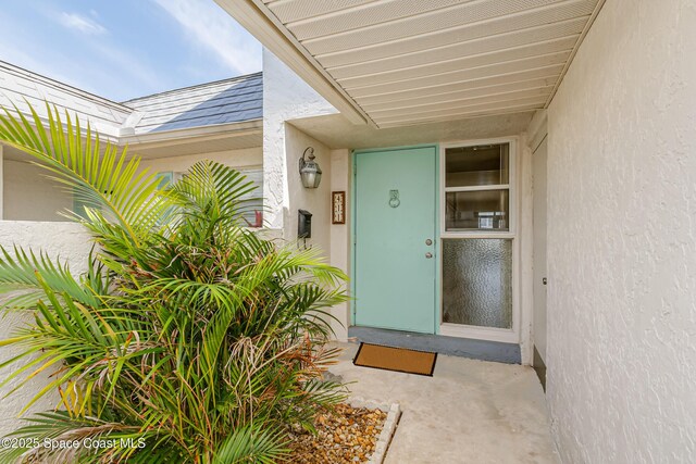 411 Dove Ln Unit 6-11, Satellite Beach, FL 32937 - doorway to property featuring stucco siding