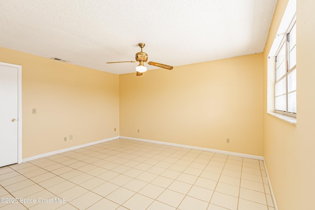 411 Dove Ln Unit 6-11, Satellite Beach, FL 32937 - unfurnished room with a ceiling fan, a textured ceiling, and baseboards