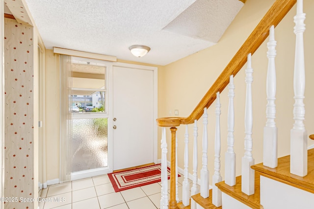 411 Dove Ln Unit 6-11, Satellite Beach, FL 32937 - entryway with a textured ceiling, baseboards, tile patterned flooring, and stairs
