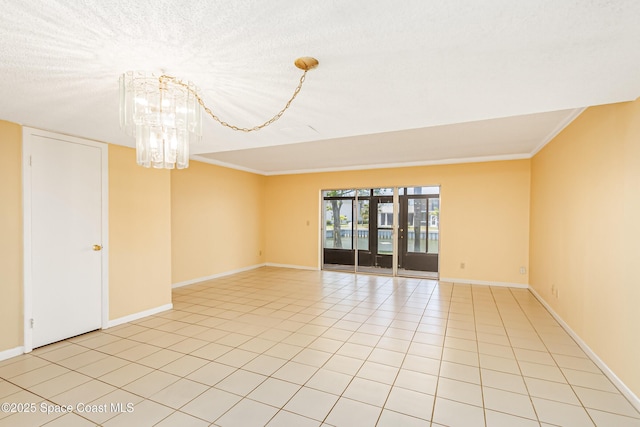 411 Dove Ln Unit 6-11, Satellite Beach, FL 32937 - empty room with baseboards, crown molding, a chandelier, and light tile patterned flooring