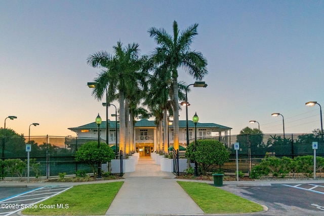 411 Dove Ln Unit 6-11, Satellite Beach, FL 32937 - property at dusk featuring fence and uncovered parking