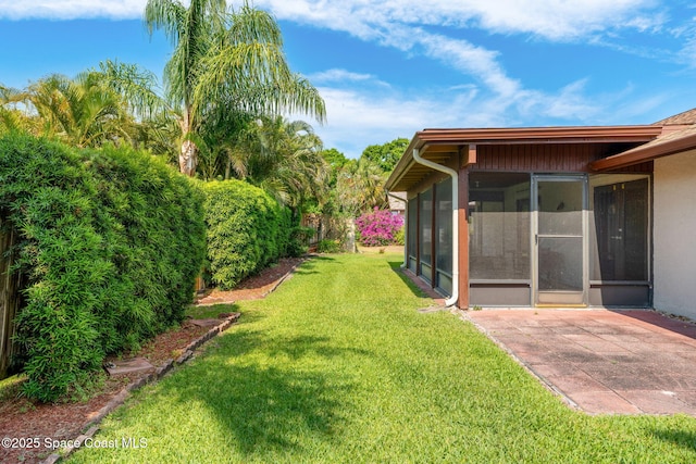 1875 Halifax Ave, Melbourne, FL 32935 - view of grassy yard with a sunroom and a patio area