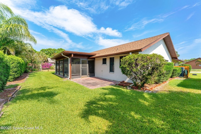 1875 Halifax Ave, Melbourne, FL 32935 - rear view of property with a sunroom, stucco siding, a lawn, and roof with shingles