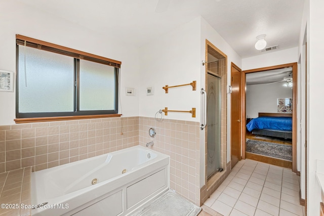 1875 Halifax Ave, Melbourne, FL 32935 - bathroom with tile patterned flooring, a shower stall, a tub with jets, ensuite bath, and a ceiling fan