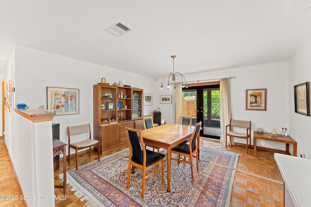 1875 Halifax Ave, Melbourne, FL 32935 - dining space with a chandelier and french doors